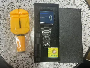 Package contents including square blue dial watch, strap adjustment tools, and battery.