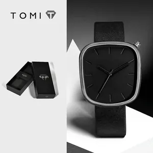 Minimalist TOMI quartz watch with pebble-shaped dial and black leather strap