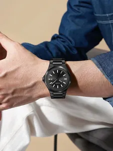 Macro view of TOMI minimalist black steel band business watch worn on a male wrist