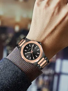 Close-up of TOMI minimalist black and gold steel band men's business watch on wrist