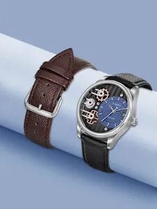 Primo piano dell'orologio al quarzo TOMI da uomo con design a ingranaggi e due cinturini.