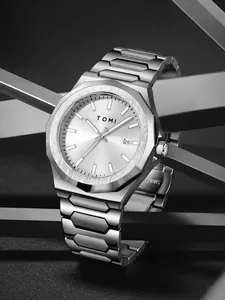 Macro close-up of TOMI silver business watch with octagonal bezel and steel band