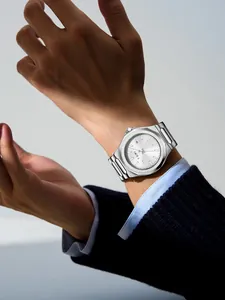 Close-up of TOMI minimalist men's silver steel strap business watch on model wrist