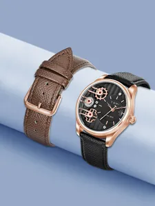 Primo piano dell'orologio TOMI con quadrante nero e cinturino extra in pelle marrone