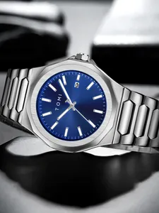 Exquisite close-up detail of TOMI men's silver steel watch with a blue sunburst dial