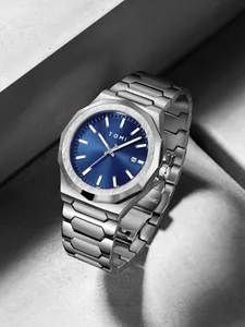 Macro view of TOMI business watch with blue sunray dial and silver steel band