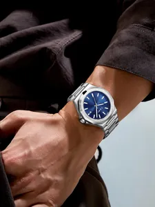 Professional men's silver stainless steel watch with sunray blue dial shown on a wrist