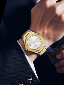 Detail view of a TOMI men's silver and gold steel watch worn with a business suit sleeve