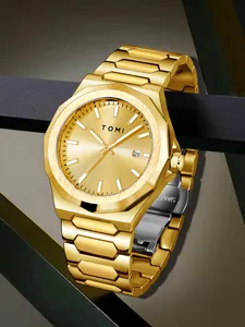 Close-up of a gold business watch with an octagonal bezel and stainless steel link bracelet.
