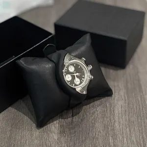Macro view of a unique Y2K-style distorted silver quartz watch with a black multi-dial face.