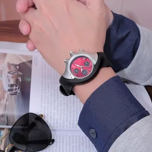Close-up of a futuristic Y2K style silver quartz watch with a pink dial on wrist.