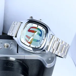 Close-up of a Y2K vintage silver quartz watch with a colorful dial on a camera prop