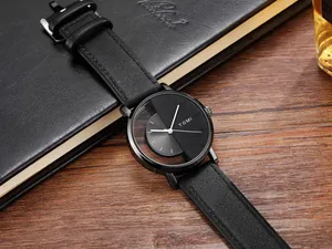Detailed view of black quartz watch with unique hollow half-transparent dial design