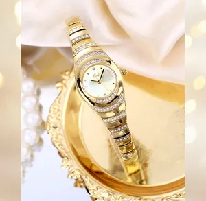 Close-up of GEDI gold-tone women's bracelet watch with sparkling rhinestone details