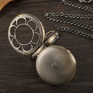 Detailed view of bronze pocket watch with hollow petal flip cover and thick chain