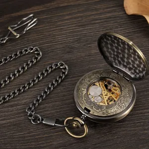 Detail view of vintage mechanical pocket watch with skeleton movement and floral case