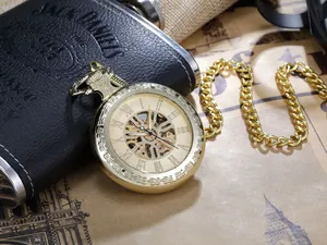 Close-up of golden hollow mechanical pocket watch with Roman numerals
