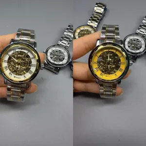 Close-up detail of WINNER men's skeleton mechanical watch with two-tone band