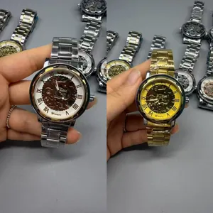 Detailed view of Winner men's skeleton mechanical watches with gold and silver bands