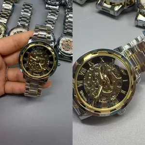 Detailed view of WINNER men's mechanical skeleton watch with gold and silver strap