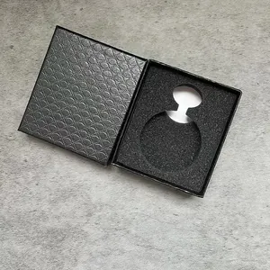 Close-up detail of open black pocket watch box with diamond texture and foam insert