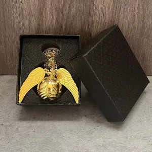 Detailed view of a golden snitch pocket watch inside a diamond-textured black gift box.