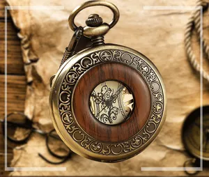 Gros plan d'une montre à gousset mécanique vintage avec gravures et insert en bois.