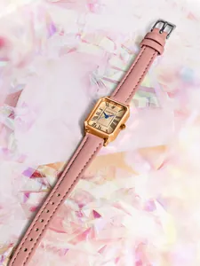 Vintage ladies rectangular quartz watch with pink leather strap on artistic background