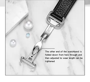 Detail showing a premium black leather watchband with adjustable silver deployment clasp mechanism