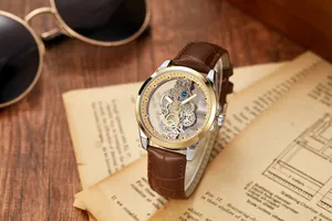 Detailed macro shot of a men's skeleton watch with gold bezel and brown leather strap.