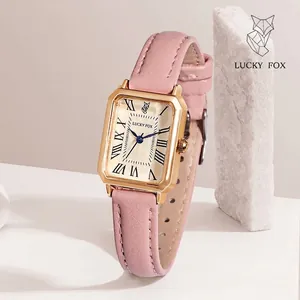Vintage rectangular gold watch for women with pink leather strap and Roman numeral dial