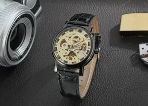Luxury black skeleton mechanical watch featuring golden gears and genuine leather strap.