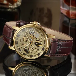 Close-up detail of T-Winner gold skeleton mechanical watch with luxury brown leather strap