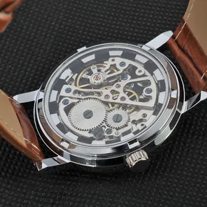 Close-up of a mechanical skeleton watch movement showing intricate silver gears and jewels.