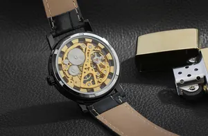Close-up of golden skeleton mechanical movement of T-Winner watch with leather strap