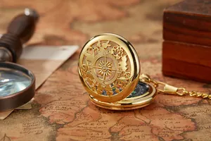 Antiek gouden zakkompas met klapdeksel en patroon op een oude nautische zeekaart