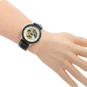 T-Winner skeleton automatic mechanical watch with black leather strap on person's wrist
