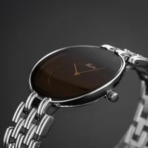 Close-up of MISSFOX vintage round watch with silver metal bracelet and brown dial