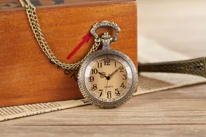 Detailed view of a vintage bronze quartz pocket watch featuring ornate case carvings