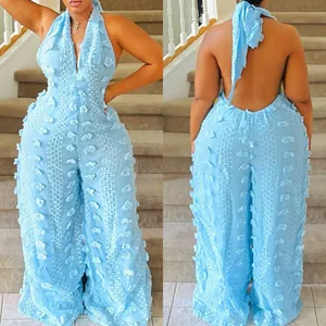 Sky blue textured halter neck jumpsuit featuring a backless tie detail and wide legs