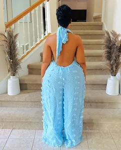 Detail back view of a tufted light blue halter neck jumpsuit featuring a backless design.
