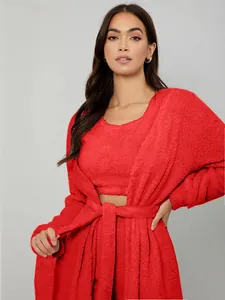 Close-up of red fuzzy three-piece loungewear set showing the soft plush robe texture.