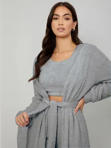 Close-up detail of grey plush three-piece loungewear set featuring soft fleece robe and belt