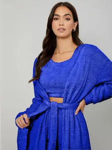 Detailed view of soft blue fuzzy three-piece loungewear set with robe and crop top