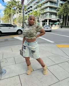 Street style distressed denim shorts with ripped details and a light blue vintage wash