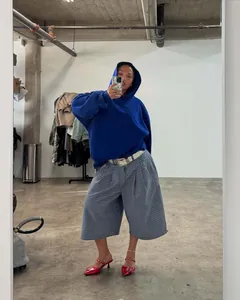 Streetwear style loose plaid wide-leg culottes worn by a model in a mirror selfie.