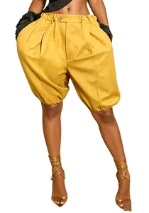 Close-up of vibrant yellow lantern shorts with pleated waist and elastic cuffs on white
