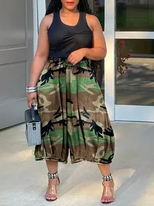 A detailed view showing the trendy camouflage print and loose fit of these harem pants