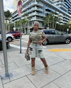 Street style shot of fashionable distressed ripped denim shorts with patchwork detail
