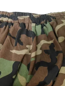 Detail of camouflage lantern pants with elastic waistband and gathered fabric texture